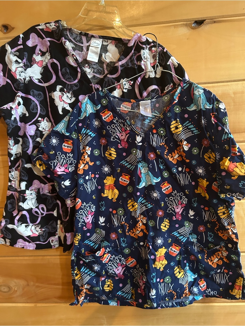 Two ladies size Large Disney scrub tops